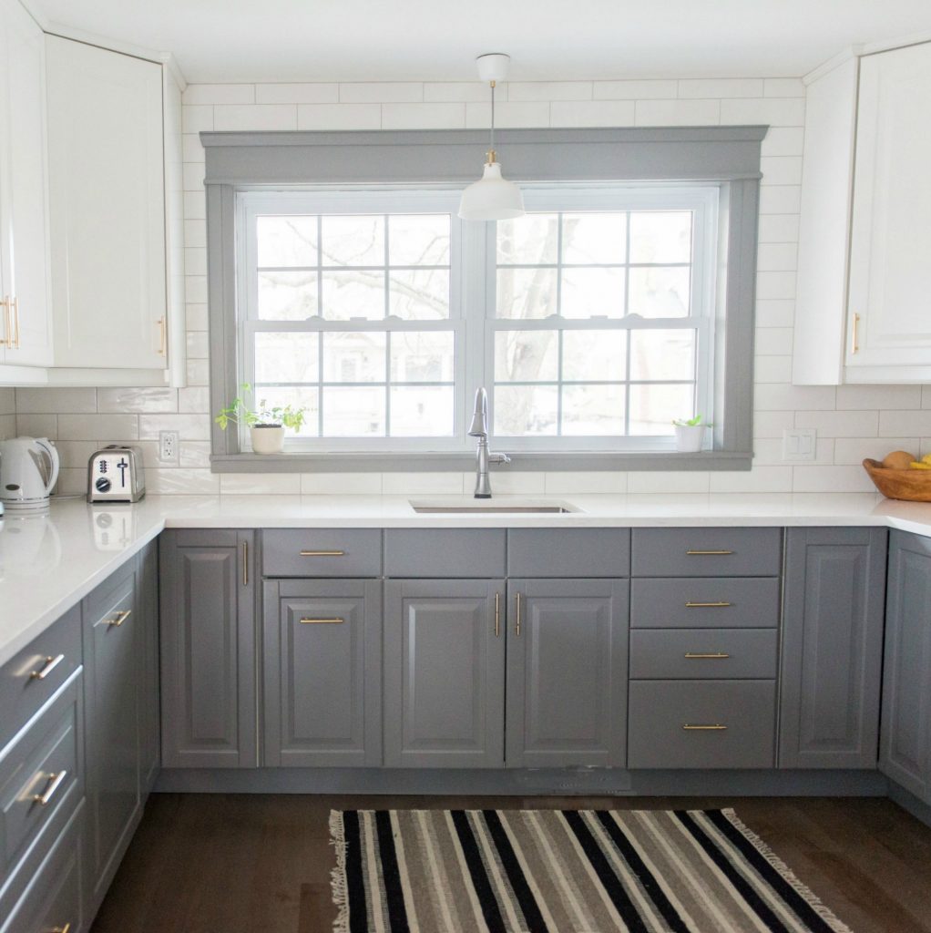 A gray and white budget friendly kitchen makeover using IKEA cabinetry, marble like quartz countertops, subway tile backsplash, and gold hardware. A timeless, bright and classic kitchen design / renovation! Click through to the blog for the full source list and DIY how-to's!