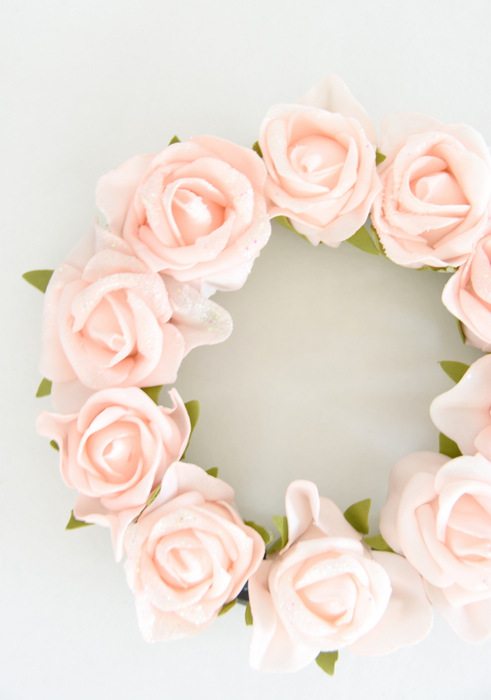 Want to make a spring or summer wreath? This sweet pink floral wreath is a simple DIY project using dollar store materials. Would be really cute for baby shower or bridal shower decorations! Click through for the full how-to tutorial on the blog.