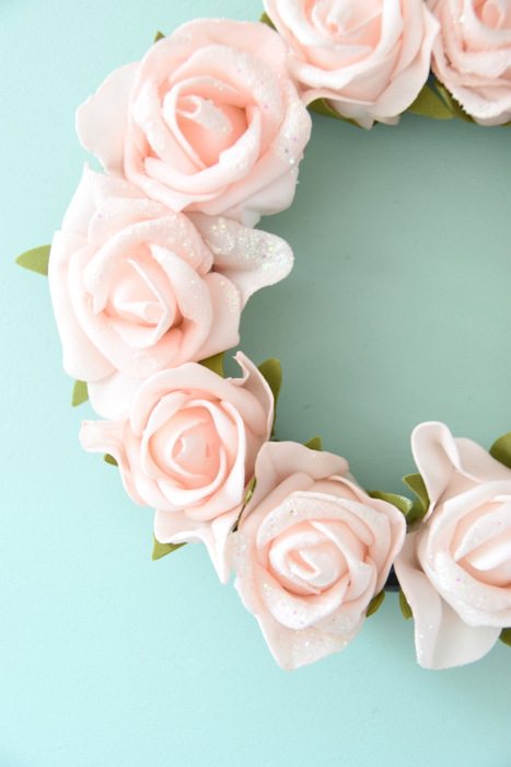 Want to make a spring or summer wreath? This sweet pink floral wreath is a simple DIY project using dollar store materials. Would be really cute for baby shower or bridal shower decorations! Click through for the full how-to tutorial on the blog.