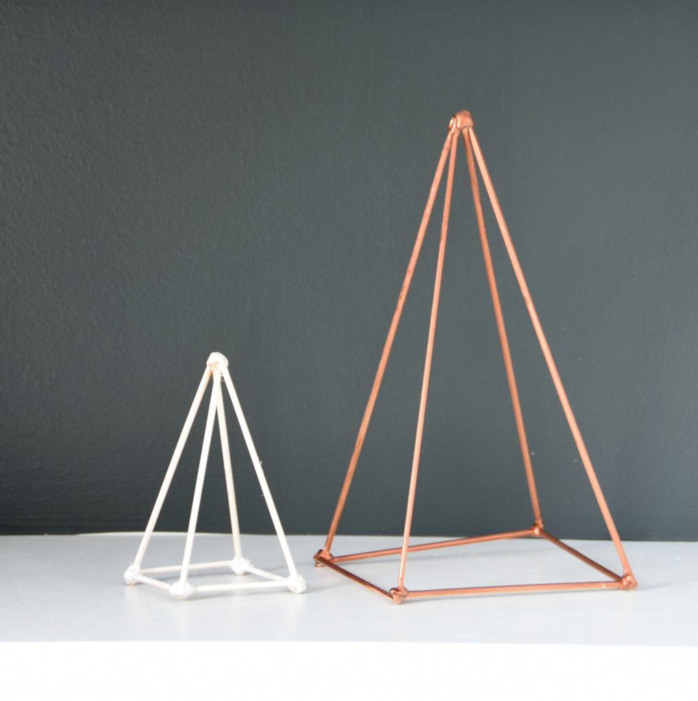 Trying to figure out how to style your shelves? Make these DIY geometric triangle sculptures out of skewers, hot glue, and spray paint. Spray them white, gold, copper, or whatever color suits your decor! An easy project with super high end look. Click through for the full how-to tutorial.