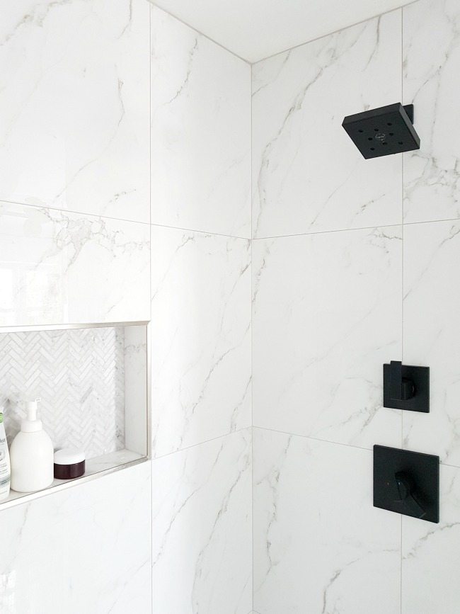 A #marble #shower featuring #matte #black #faucet. Get this #modern #spa #bathroom look for less!
